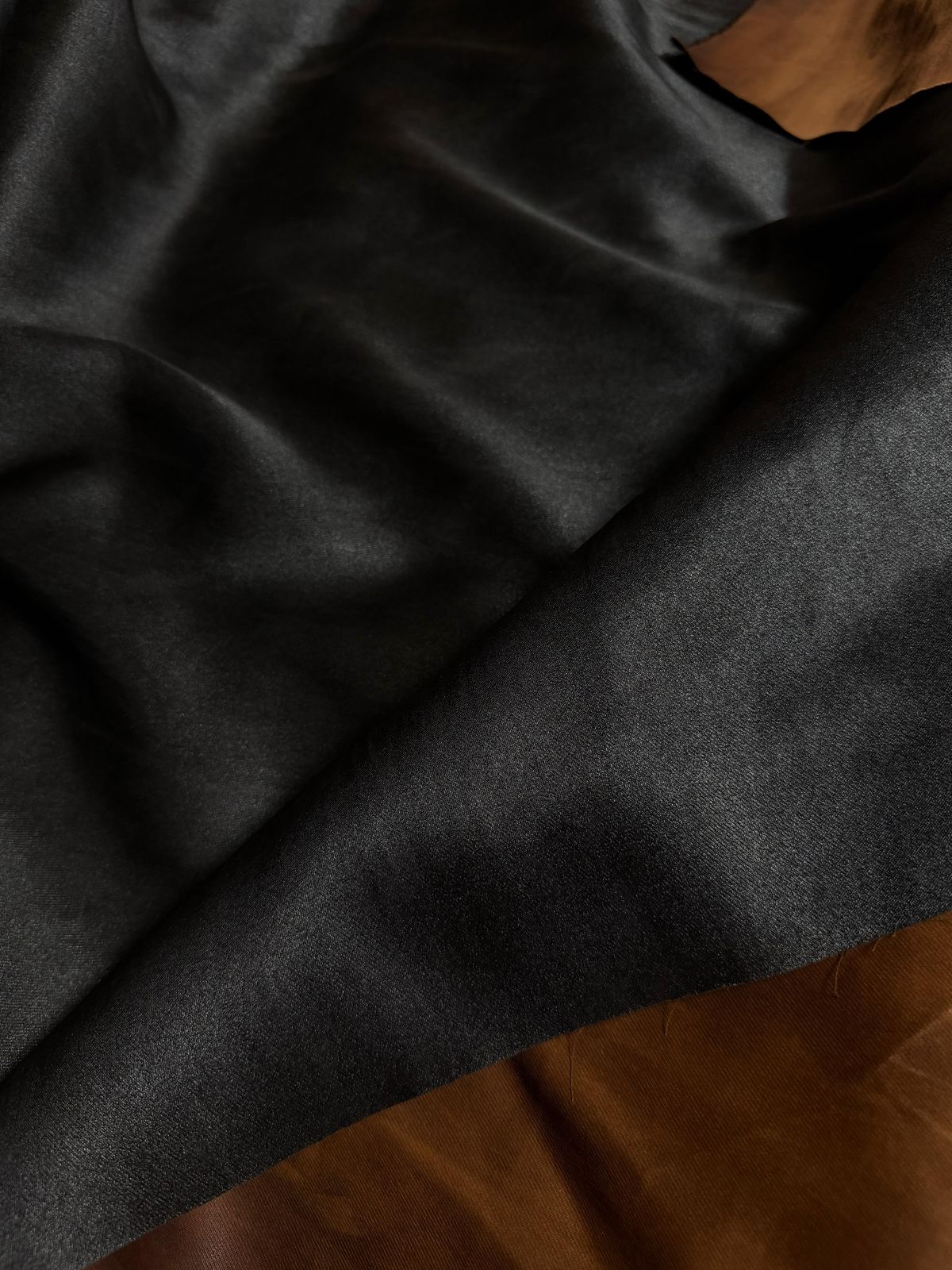 Mud dye silk fabric showing black and terracotta faces